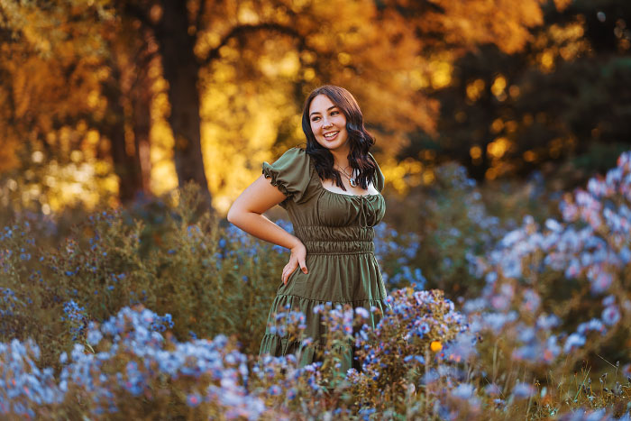 Girl in olive green dress at Kathryn Albertson Park in Boise ID surrounded by purple flowers