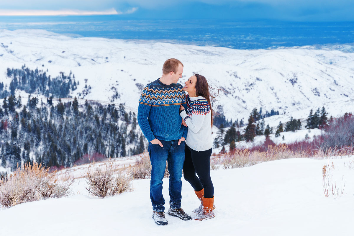 Young couple in Icelandic sweaters in snowy Idaho landscape