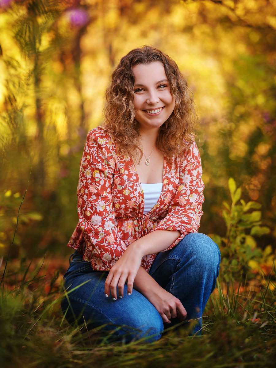 High school senior girl smiling for senior session at Kathryn Albertson Park in fall, Boise, Idaho