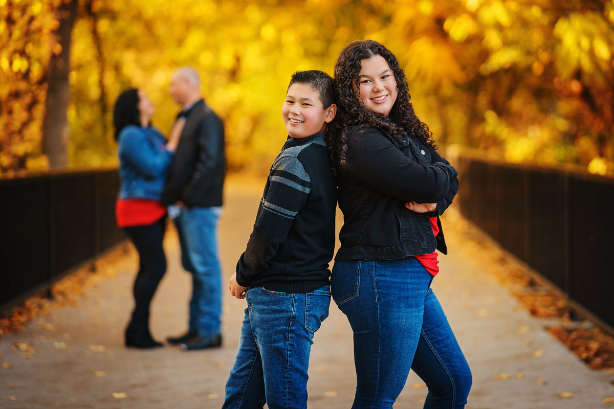 Family of four pulling faces for the camera on autumn family photoshoot in Boise