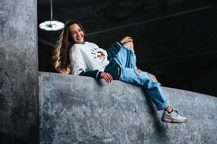 Senior photo in Boise Idaho of girl reclining on concrete wall