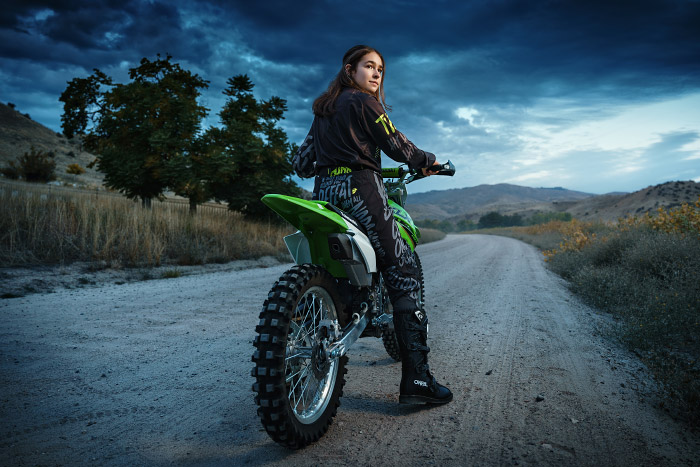 High school senior girl on dirt bike at dusk in Military Reserve Park, Boise